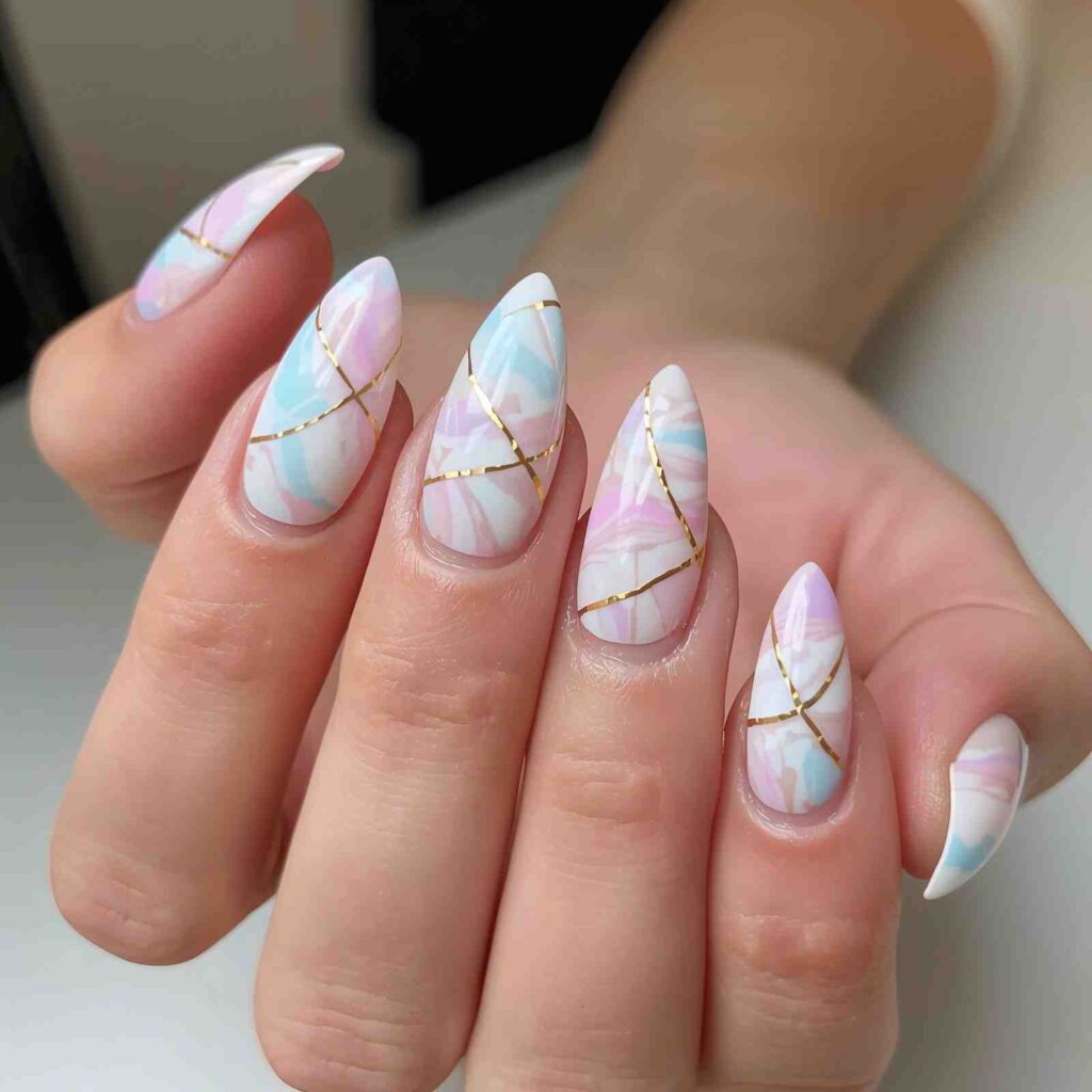 Elegant pastel marble spring nail design with thin gold veins.